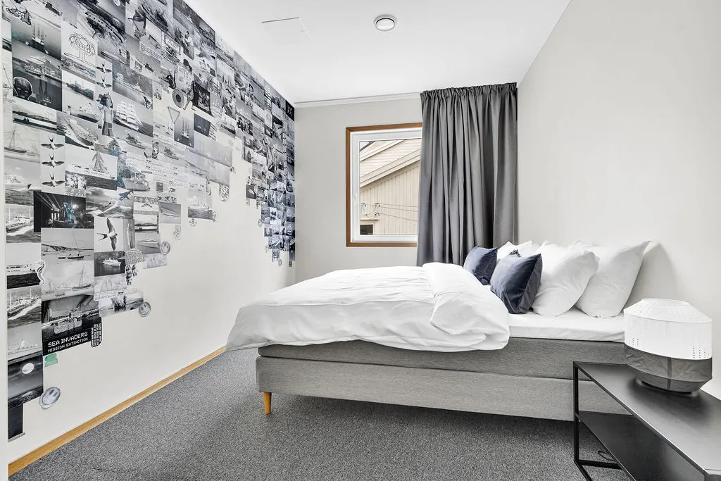 Deluxe room with a black and white mural behind the bed